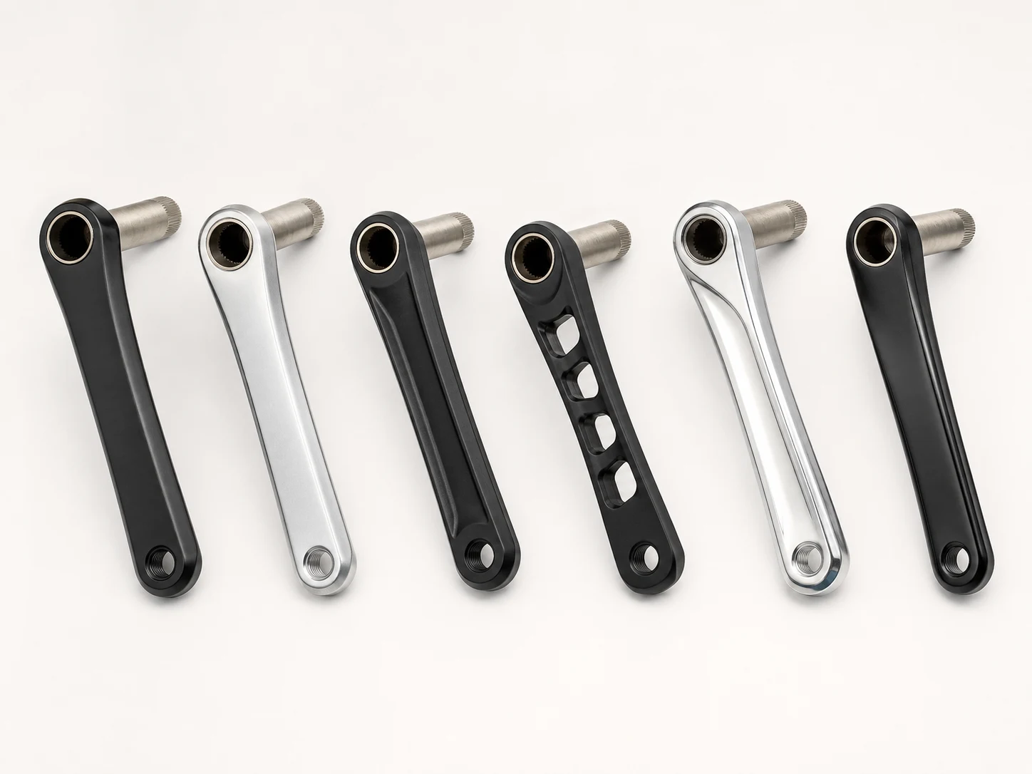 Unbranded forged bicycle crank arms in black and silver finishes
